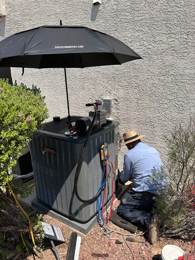 HVAC technician performing outdoor AC maintenance in West Park